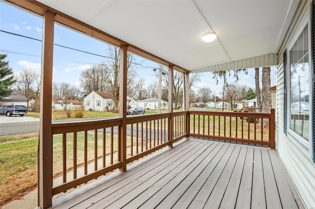 wooden terrace with a yard and covered porch