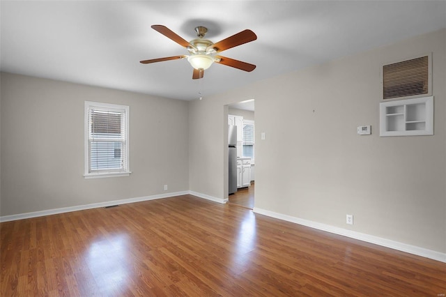 spare room with hardwood / wood-style floors and ceiling fan