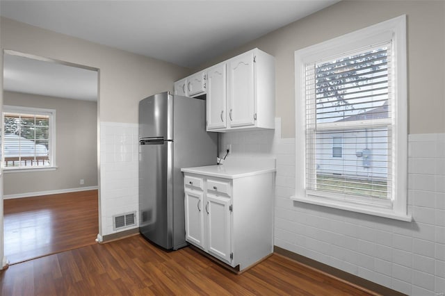 kitchen featuring white cabinets, stainless steel fridge, and dark wood-type flooring