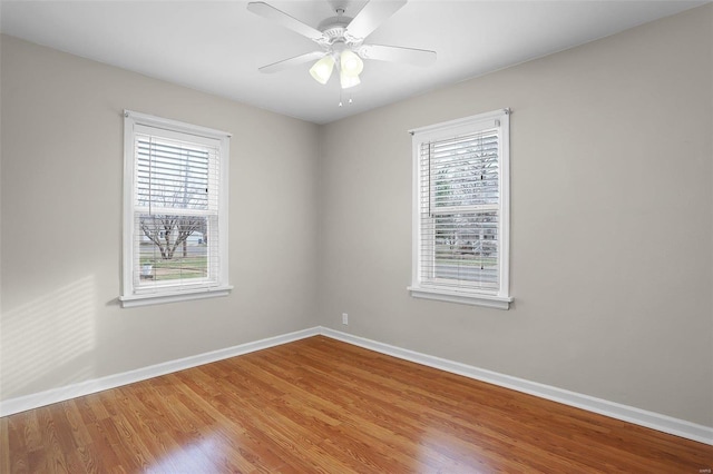 unfurnished room with hardwood / wood-style floors and ceiling fan