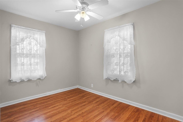 empty room featuring ceiling fan and hardwood / wood-style floors