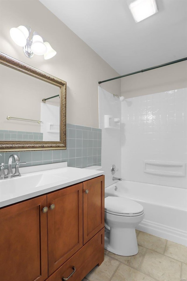 full bathroom featuring decorative backsplash, bathtub / shower combination, vanity, tile walls, and toilet