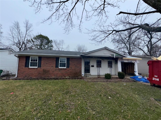 ranch-style house with covered porch and a front lawn