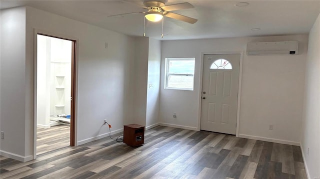 entryway featuring dark hardwood / wood-style floors, a wall mounted AC, and ceiling fan