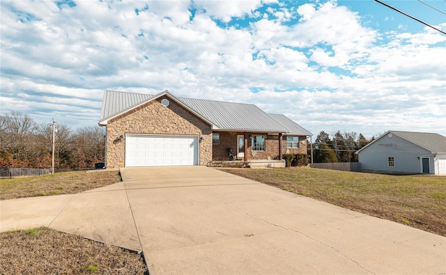 view of front of property featuring a garage and a front yard