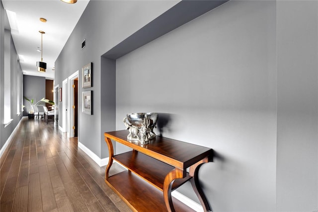 corridor featuring dark wood-type flooring