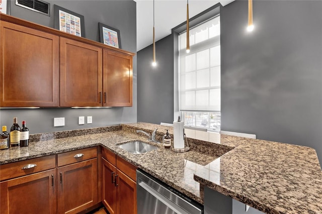 kitchen featuring dishwasher, sink, hanging light fixtures, kitchen peninsula, and dark stone countertops