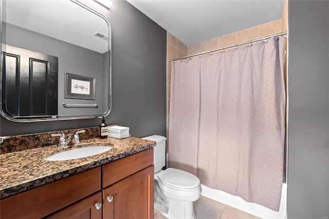 bathroom featuring tile patterned floors, vanity, and toilet