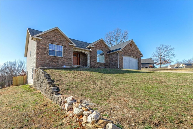 view of front of home featuring a front yard and a garage