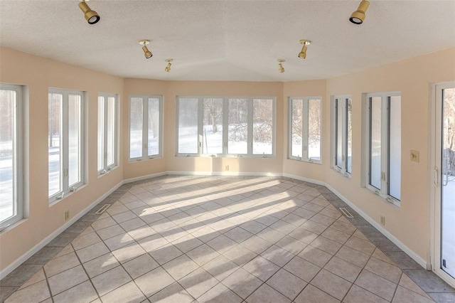 unfurnished sunroom with vaulted ceiling