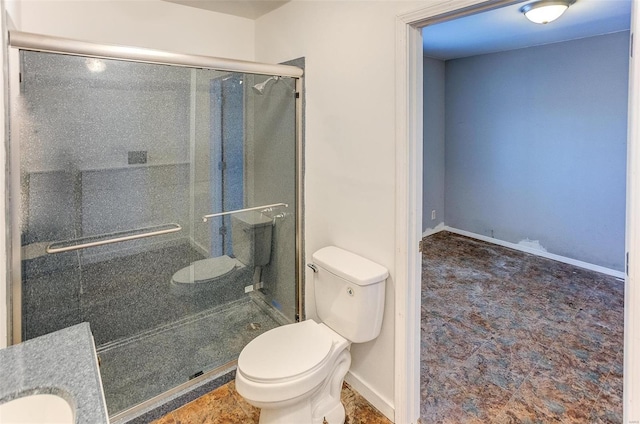 bathroom with toilet, a shower with shower door, and sink