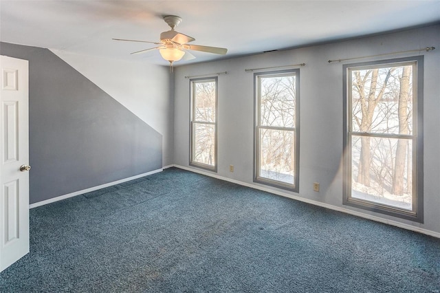 carpeted empty room featuring ceiling fan and lofted ceiling