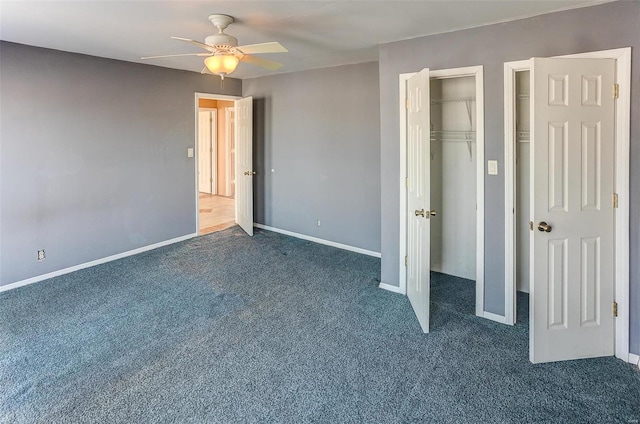 unfurnished bedroom with dark colored carpet and ceiling fan