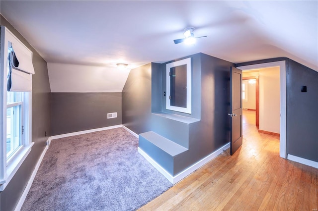 bonus room featuring ceiling fan, light hardwood / wood-style flooring, and vaulted ceiling