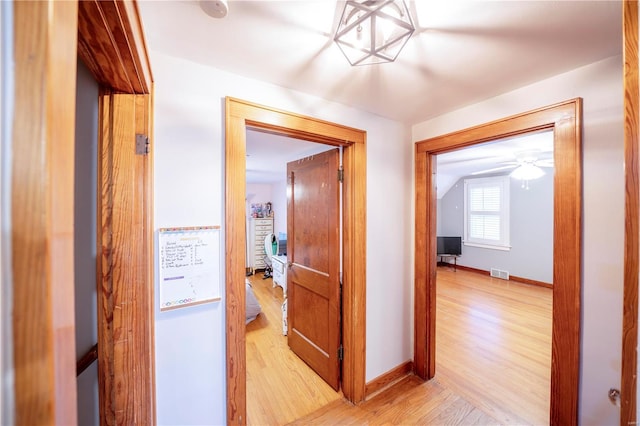 hall with light hardwood / wood-style flooring