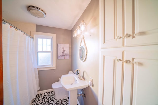 bathroom with tile patterned flooring and toilet