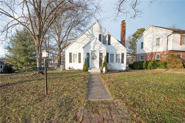 view of front of property featuring a front yard and a chimney