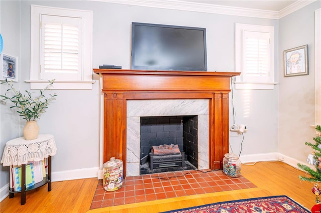 room details featuring baseboards, a fireplace with flush hearth, wood finished floors, and crown molding