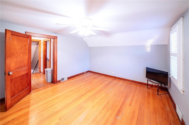 bonus room with lofted ceiling, light wood-style flooring, visible vents, and baseboards