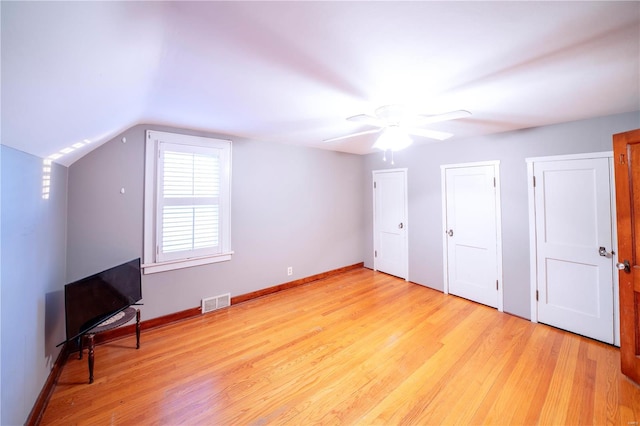 additional living space with light wood-type flooring, visible vents, and baseboards