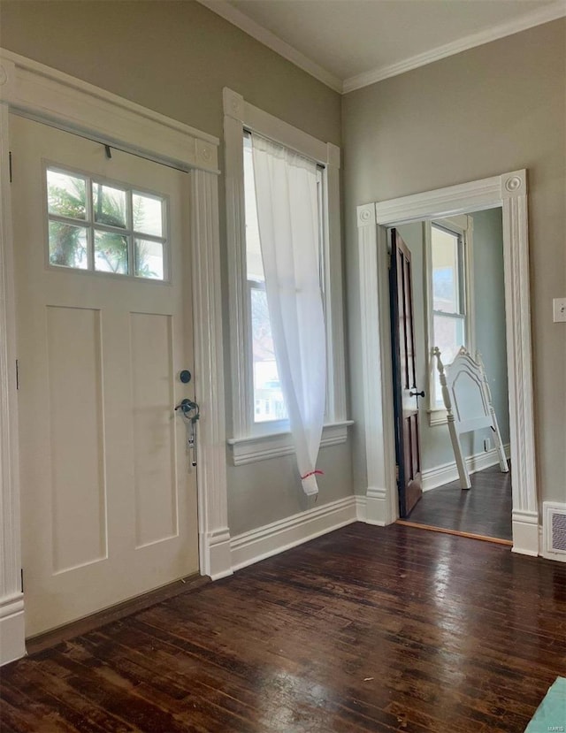 entrance foyer with a healthy amount of sunlight, dark wood-type flooring, and crown molding