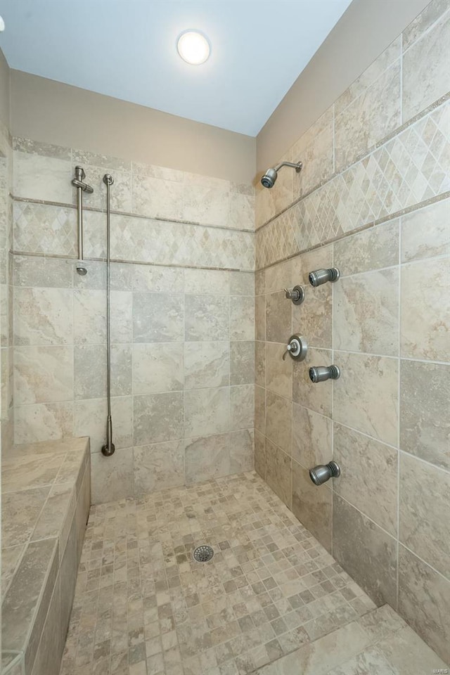 bathroom with a tile shower