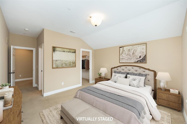 bedroom with lofted ceiling, light colored carpet, visible vents, baseboards, and a spacious closet