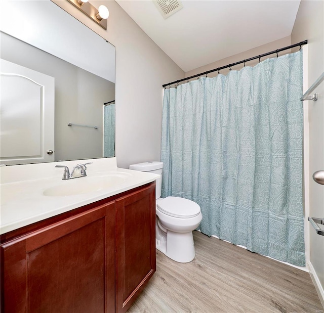 bathroom featuring hardwood / wood-style floors, vanity, and toilet