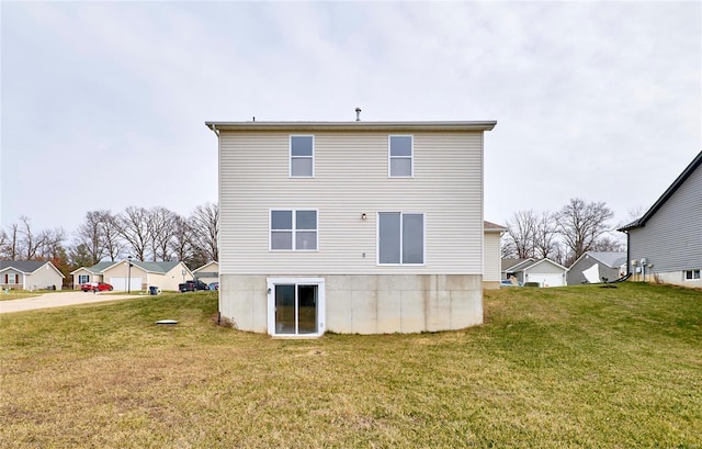 rear view of property featuring a lawn