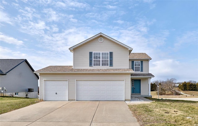 view of property with a garage and a front lawn