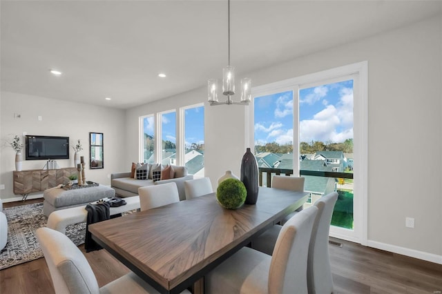 dining room with a chandelier, dark hardwood / wood-style flooring, and a healthy amount of sunlight