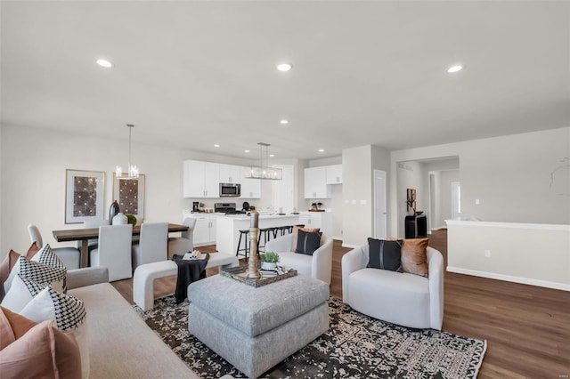 living room featuring a chandelier and hardwood / wood-style flooring