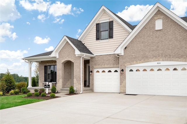 view of front of home with a porch and a garage