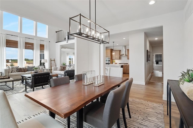 dining space featuring an inviting chandelier and light wood-type flooring