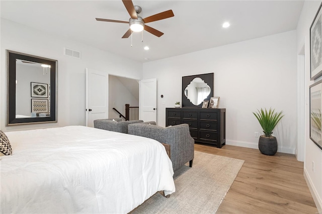 bedroom with light wood-type flooring and ceiling fan