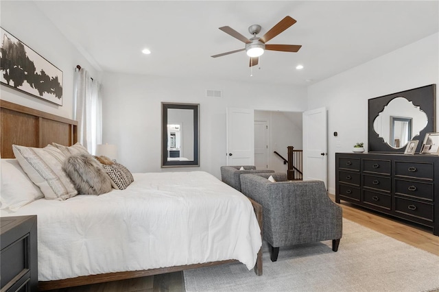 bedroom featuring ceiling fan and light hardwood / wood-style flooring