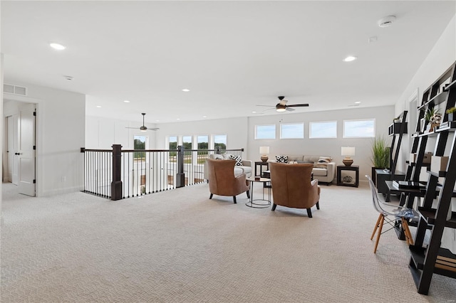 carpeted living room with ceiling fan