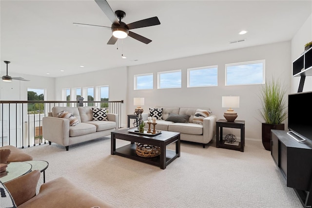 living room featuring ceiling fan and light colored carpet