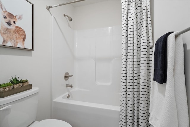 bathroom with shower / bath combination with curtain and toilet