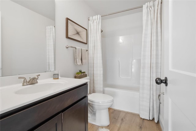 full bathroom featuring hardwood / wood-style flooring, vanity, toilet, and shower / bathtub combination with curtain