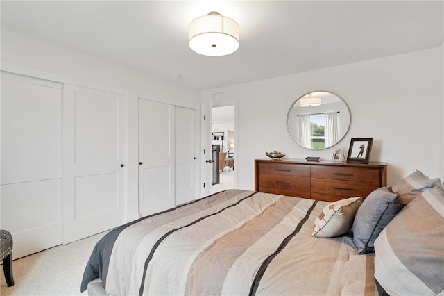 carpeted bedroom with multiple closets