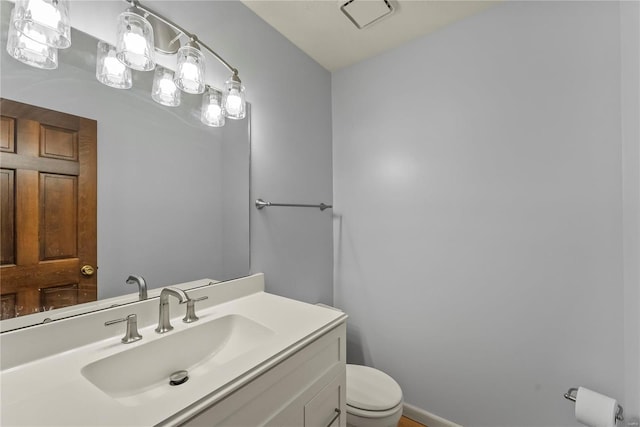 bathroom featuring toilet and vanity