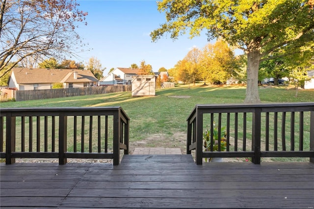 wooden terrace with a lawn and a shed