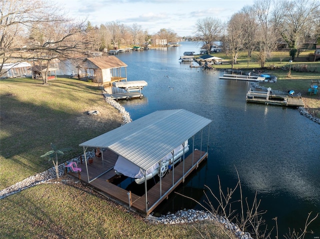 dock area with a lawn and a water view