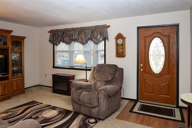 foyer featuring light colored carpet