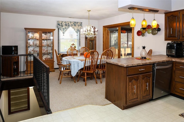 kitchen featuring dishwasher, a chandelier, hanging light fixtures, light colored carpet, and dark brown cabinetry