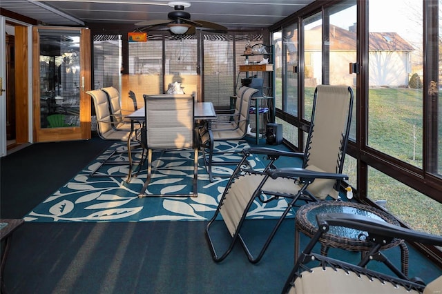 sunroom with a healthy amount of sunlight and ceiling fan