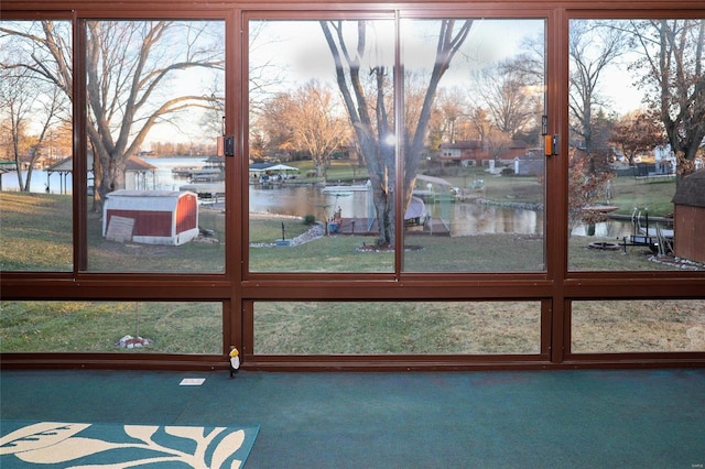 unfurnished sunroom featuring a water view