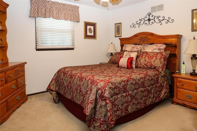 bedroom featuring light colored carpet and ceiling fan