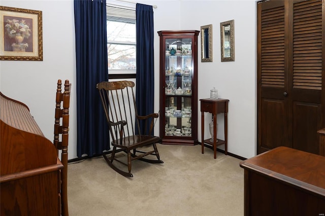 sitting room featuring light colored carpet